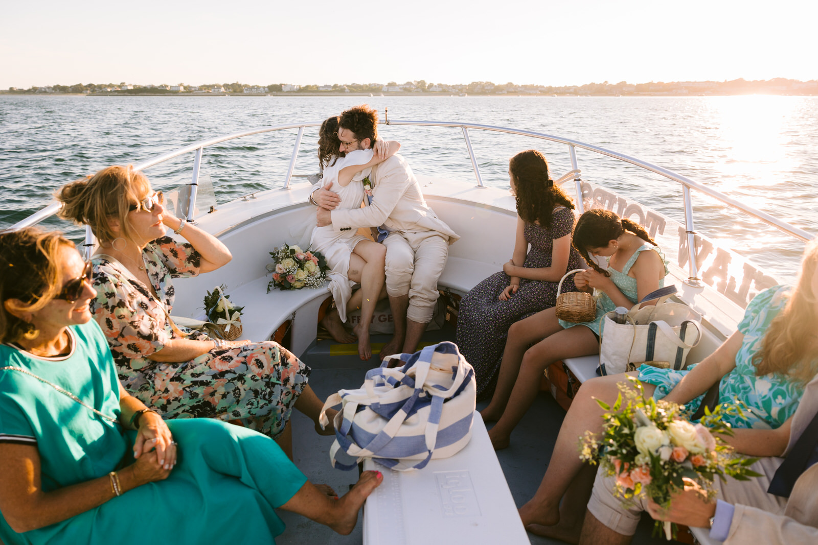 bride and groom hugging on boat ride chatham bars inn elopement