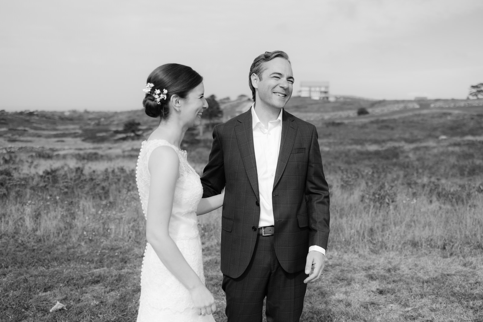 Bride and groom laughing at their friends farm for their post ceremony potraits on block island in rhode island.