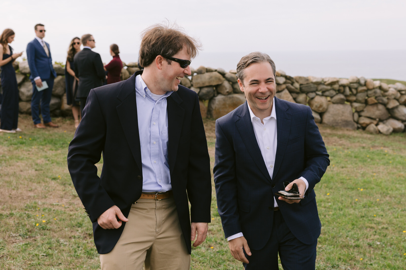 Groom and a guest laughing before the ceremony begins on block island