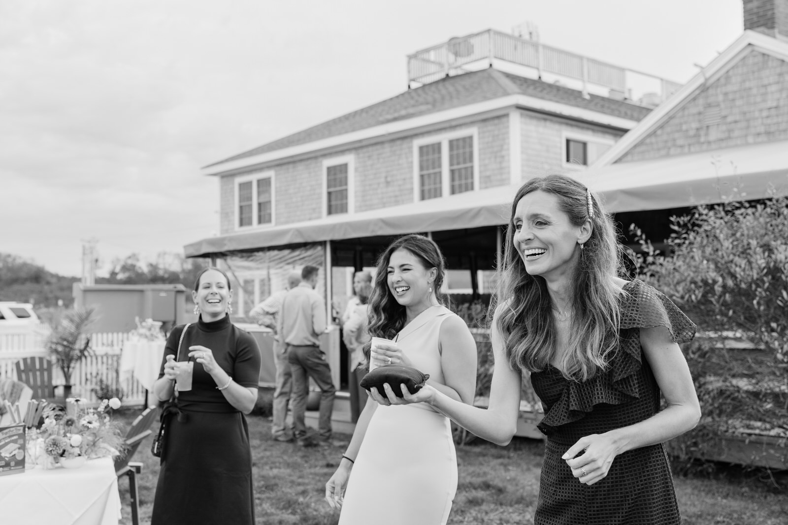 guests throwing bean bags during cocktail at a wedding on block Island.